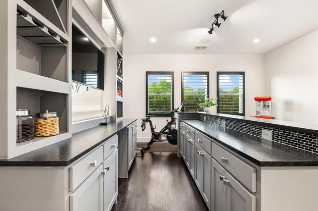 a kitchen with granite countertop a sink and a large window
