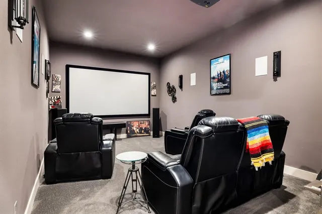 a room with furniture projector and screen