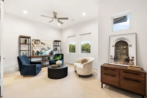 a living room with furniture a chandelier and a fireplace