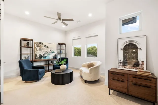 a living room with furniture a chandelier and a fireplace