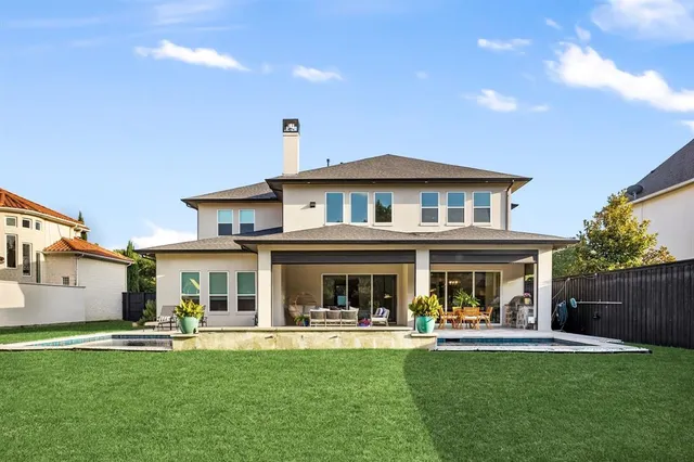 a front view of a house with swimming pool having outdoor seating