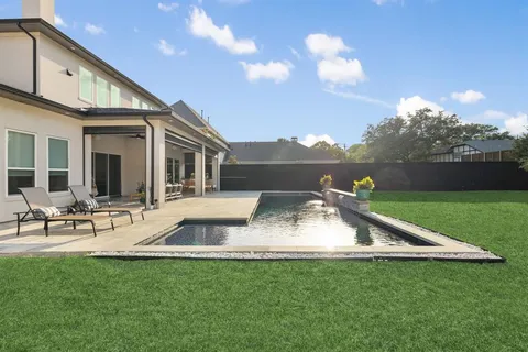 a view of a house with backyard porch and sitting area