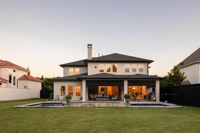 a view of a building with two windows and a yard with a small yard