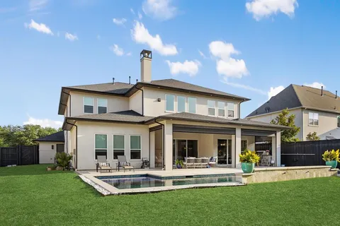 a view of a house with a yard and sitting area