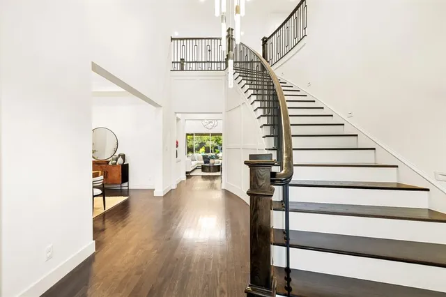 a view of entryway and hall with wooden floor