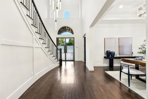 a view of entryway and hall with wooden floor