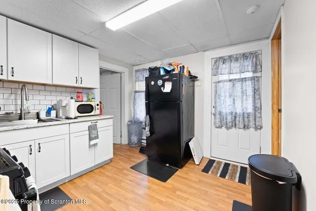 a kitchen with a stove cabinets and a refrigerator