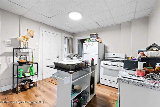 a kitchen with a white cabinets and white appliances