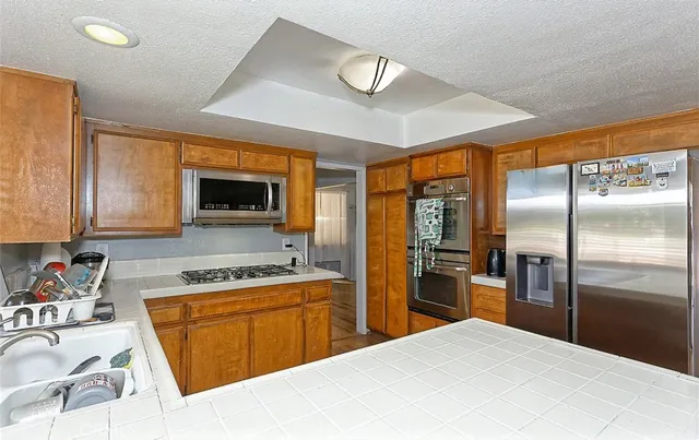 a kitchen with a refrigerator sink and microwave
