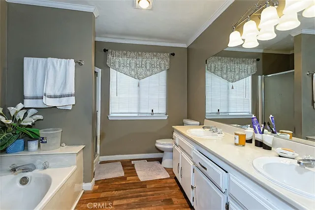 a spacious bathroom with a double vanity sink mirror and a bathtub