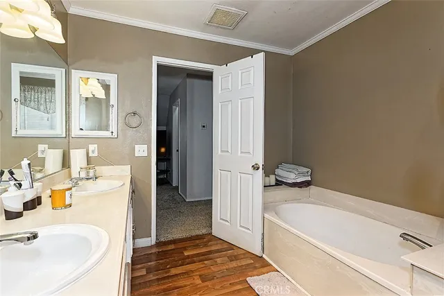 a bathroom with a tub sink and mirror