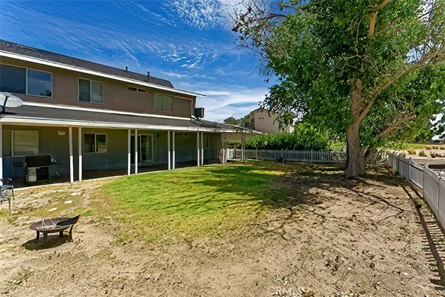 a view of a house with backyard and sitting area