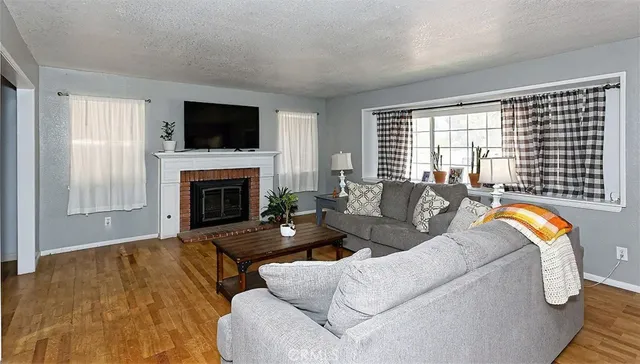a living room with furniture fireplace and flat screen tv