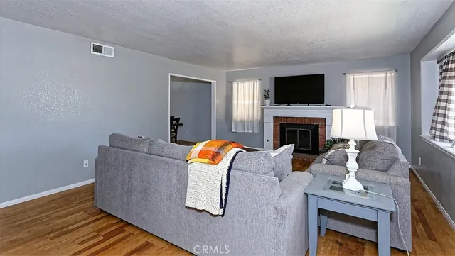 a living room with furniture fireplace and flat screen tv
