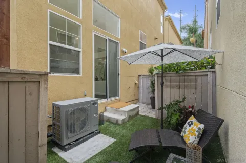 a backyard of a house with table and chairs