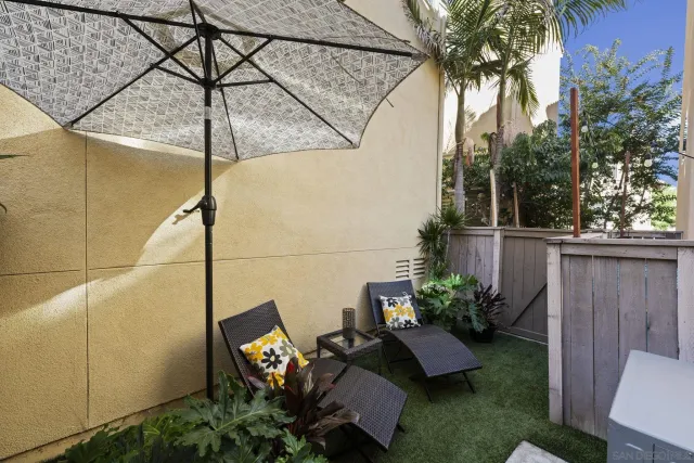 a view of a backyard with plants and a patio