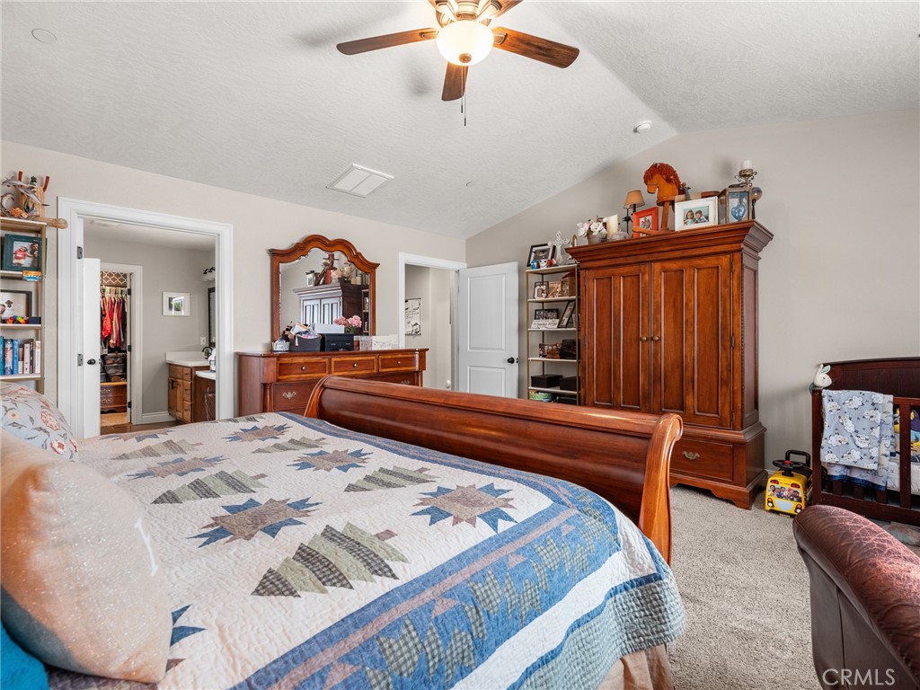 15620 Erie Road Apple Valley, CA 92307 - Photo 24 of 53 a bed sitting in a bedroom and a chandelier