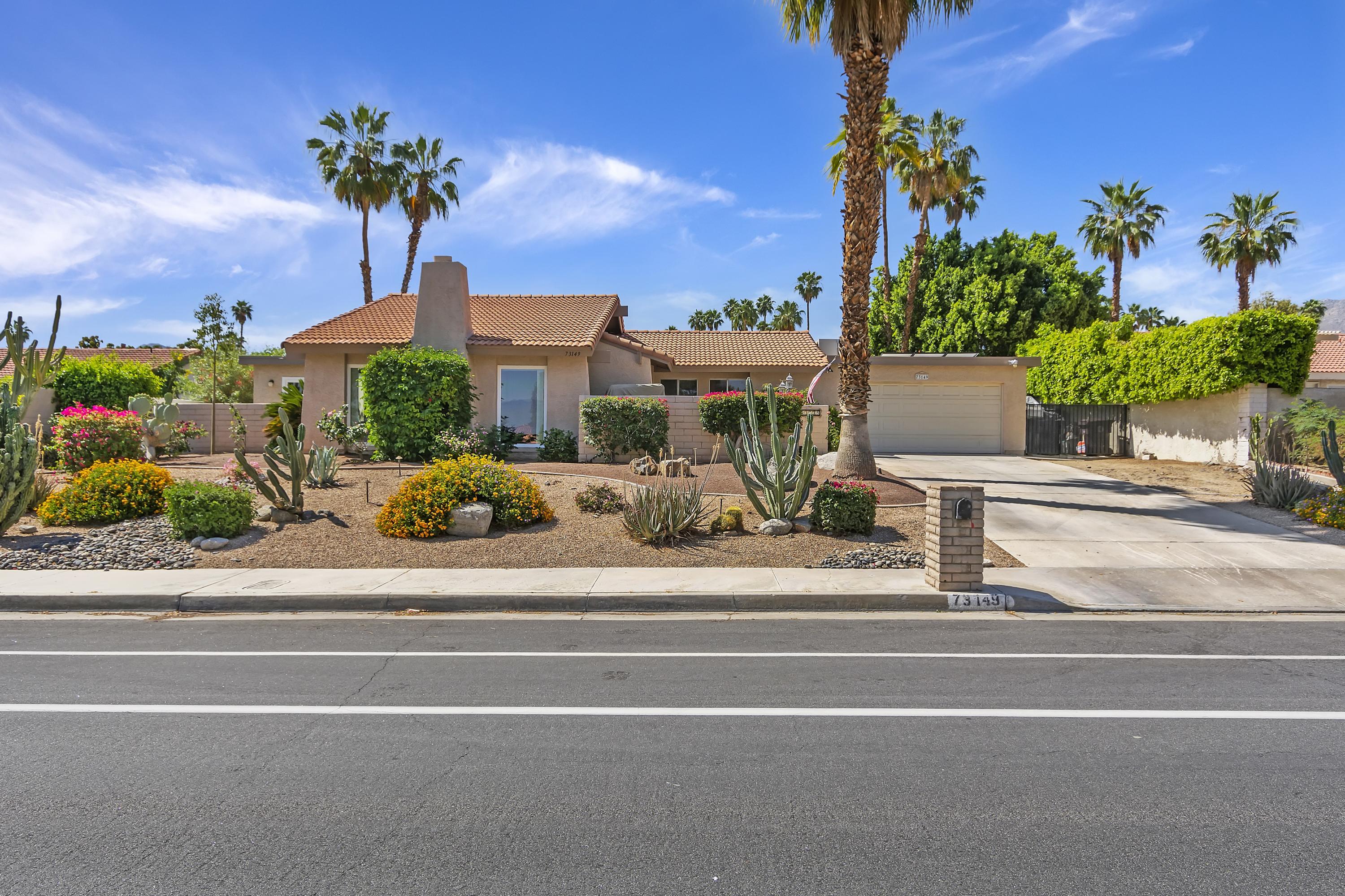 a front view of a house with a garden