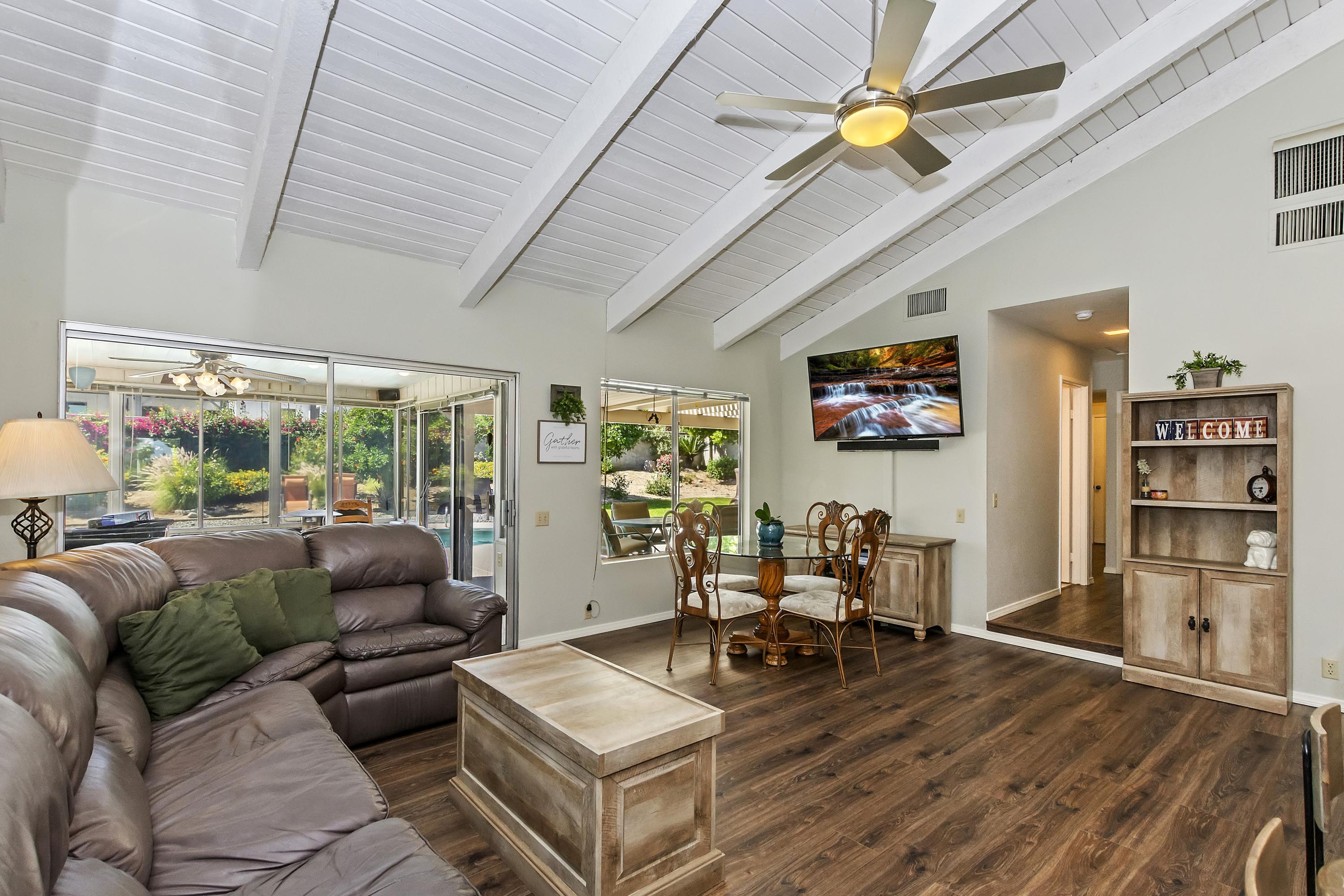 73149 Haystack Road Palm Desert, CA 92260 - Photo 12 of 32 a living room with furniture a ceiling fan and a rug