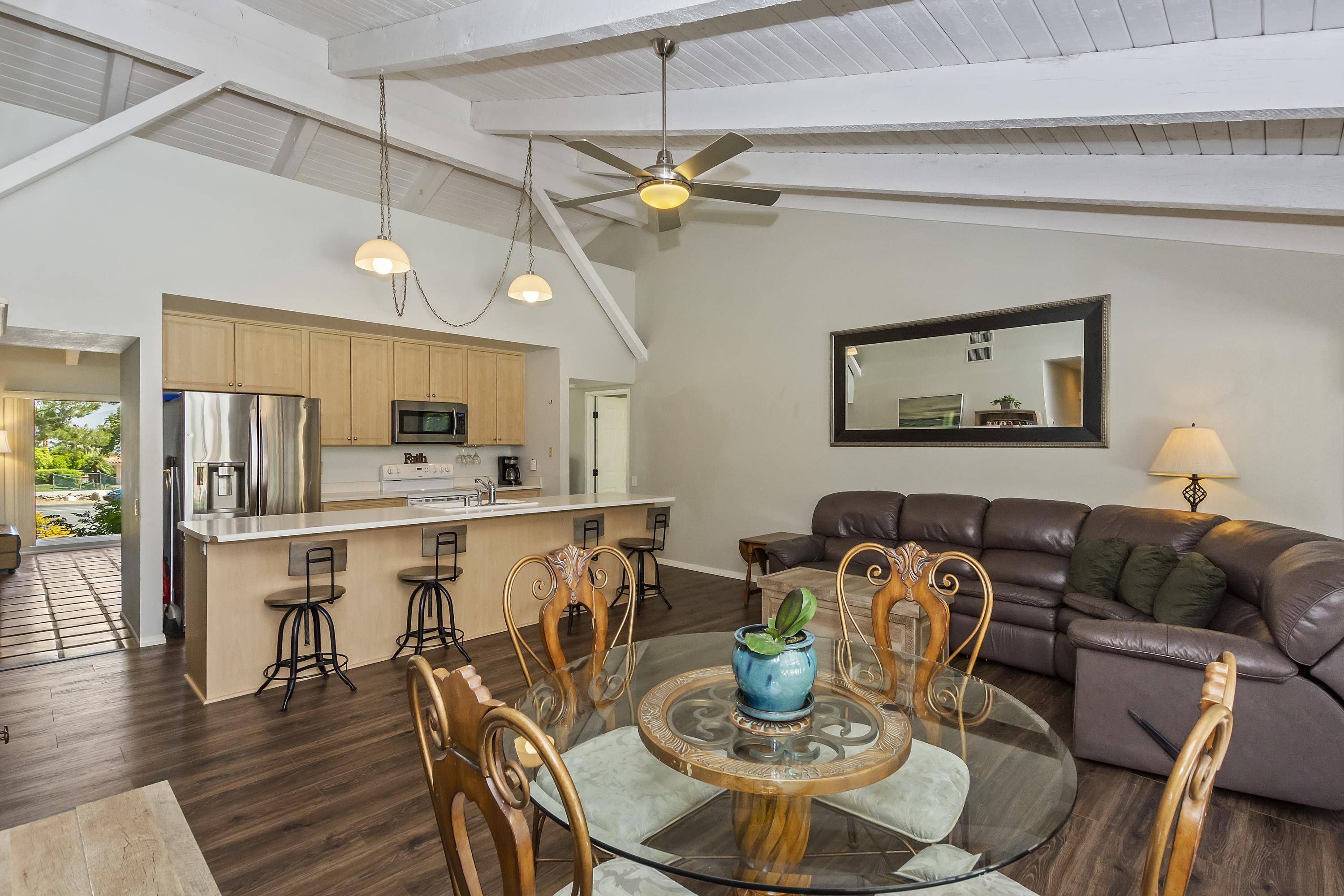 73149 Haystack Road Palm Desert, CA 92260 - Photo 13 of 32 a view of a dining room with furniture and wooden floor