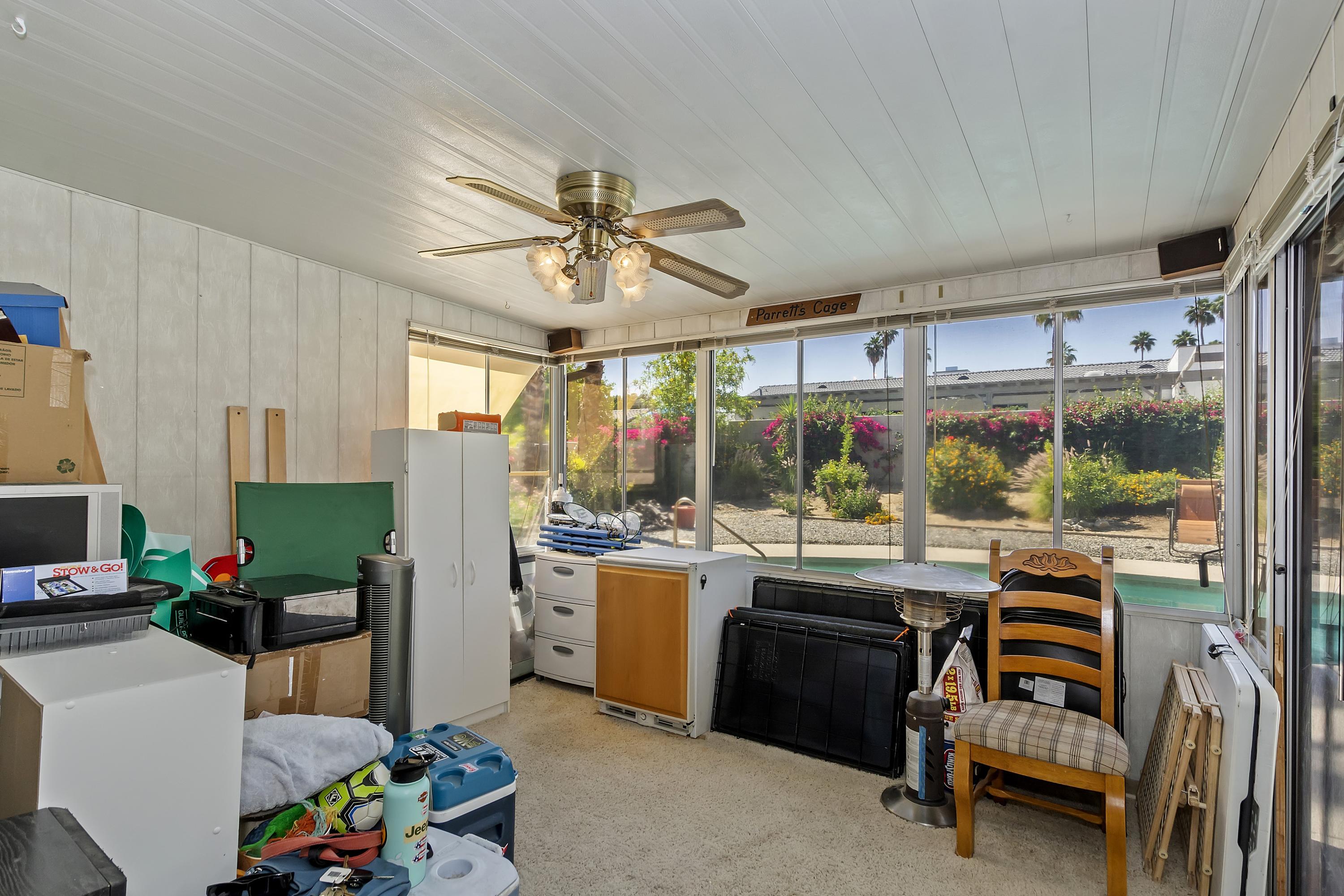 73149 Haystack Road Palm Desert, CA 92260 - Photo 14 of 32 a living room with furniture and a flat screen tv