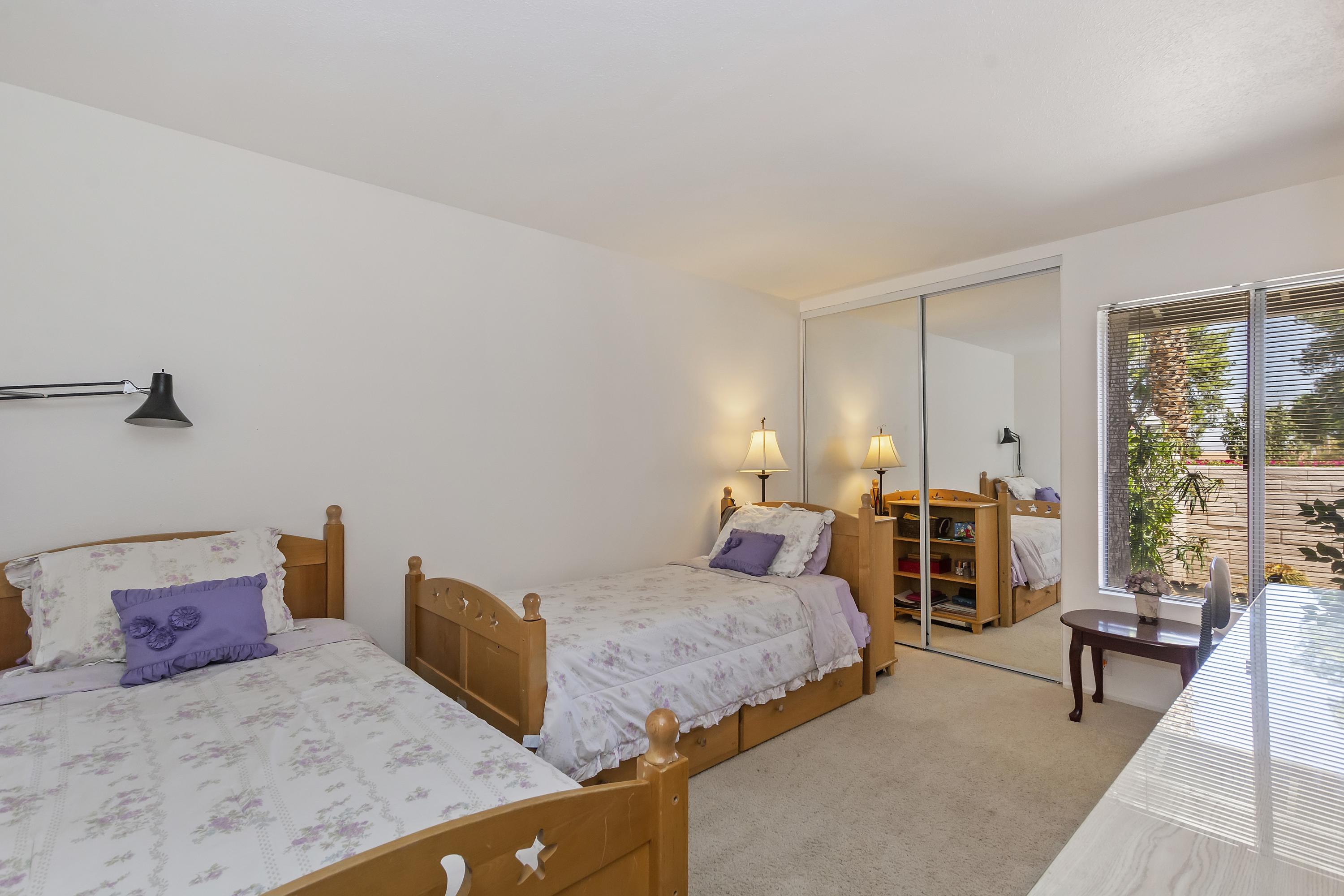 73149 Haystack Road Palm Desert, CA 92260 - Photo 15 of 32 a bedroom with furniture and a large window