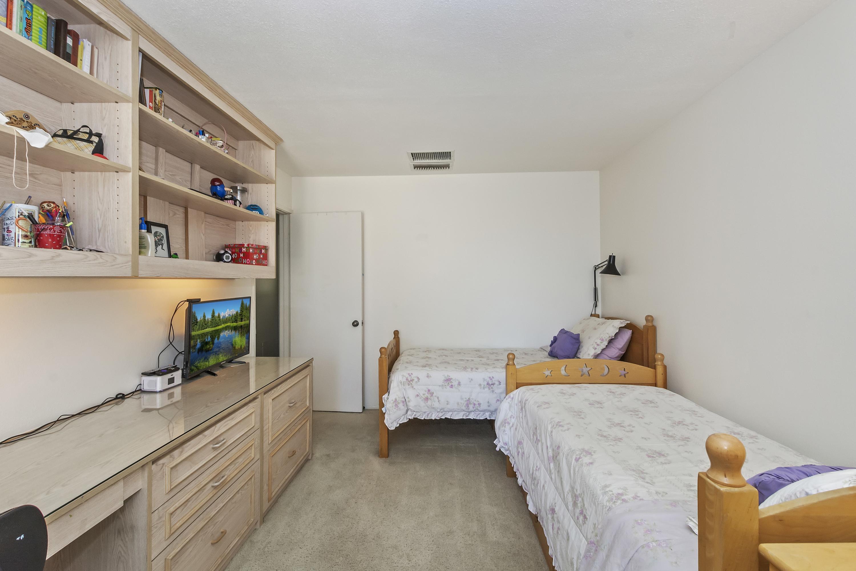 73149 Haystack Road Palm Desert, CA 92260 - Photo 16 of 32 a bedroom with bed and wooden floor