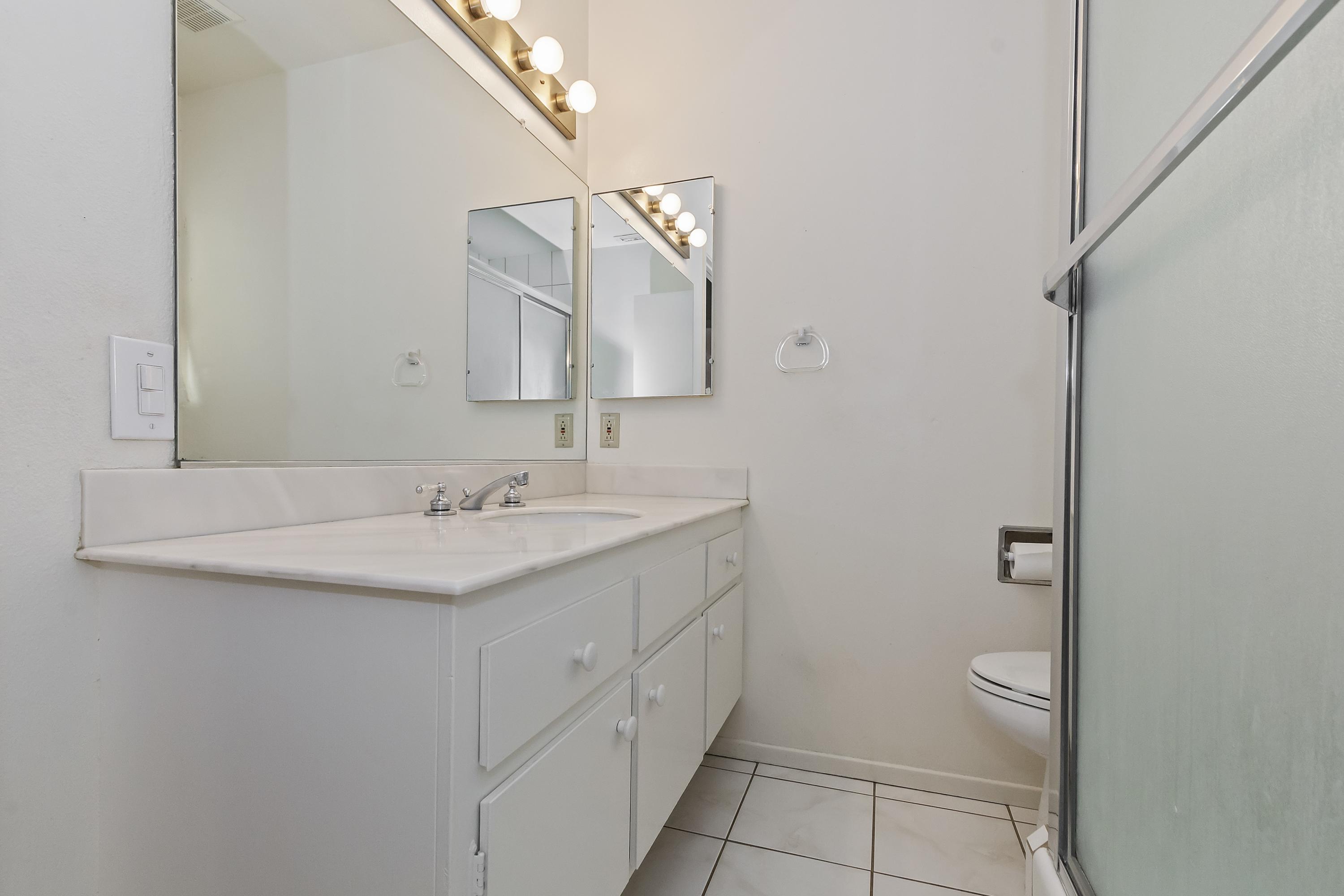 73149 Haystack Road Palm Desert, CA 92260 - Photo 17 of 32 a bathroom with a sink a toilet and a mirror