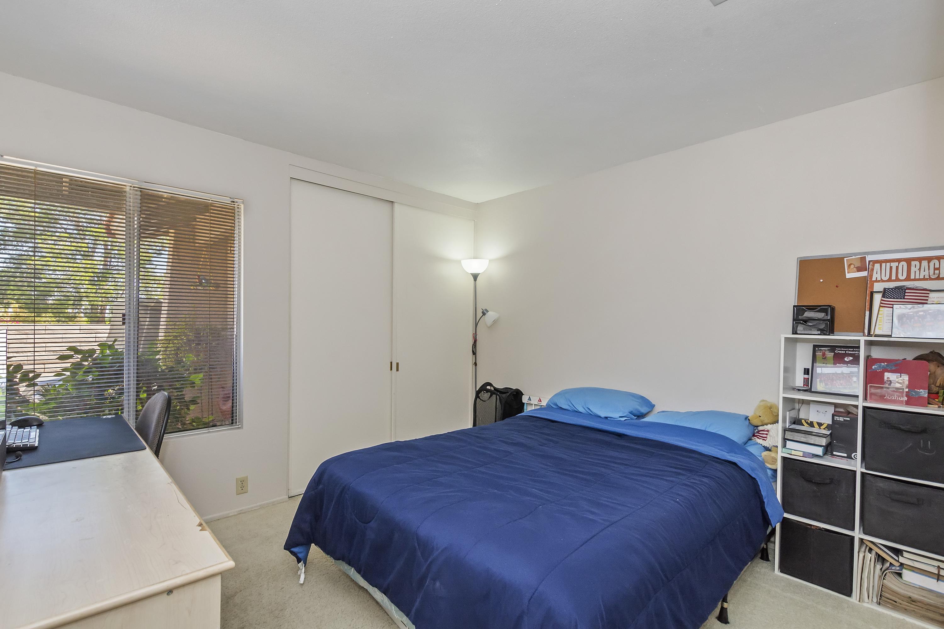 73149 Haystack Road Palm Desert, CA 92260 - Photo 18 of 32 a bedroom with a bed and a large window