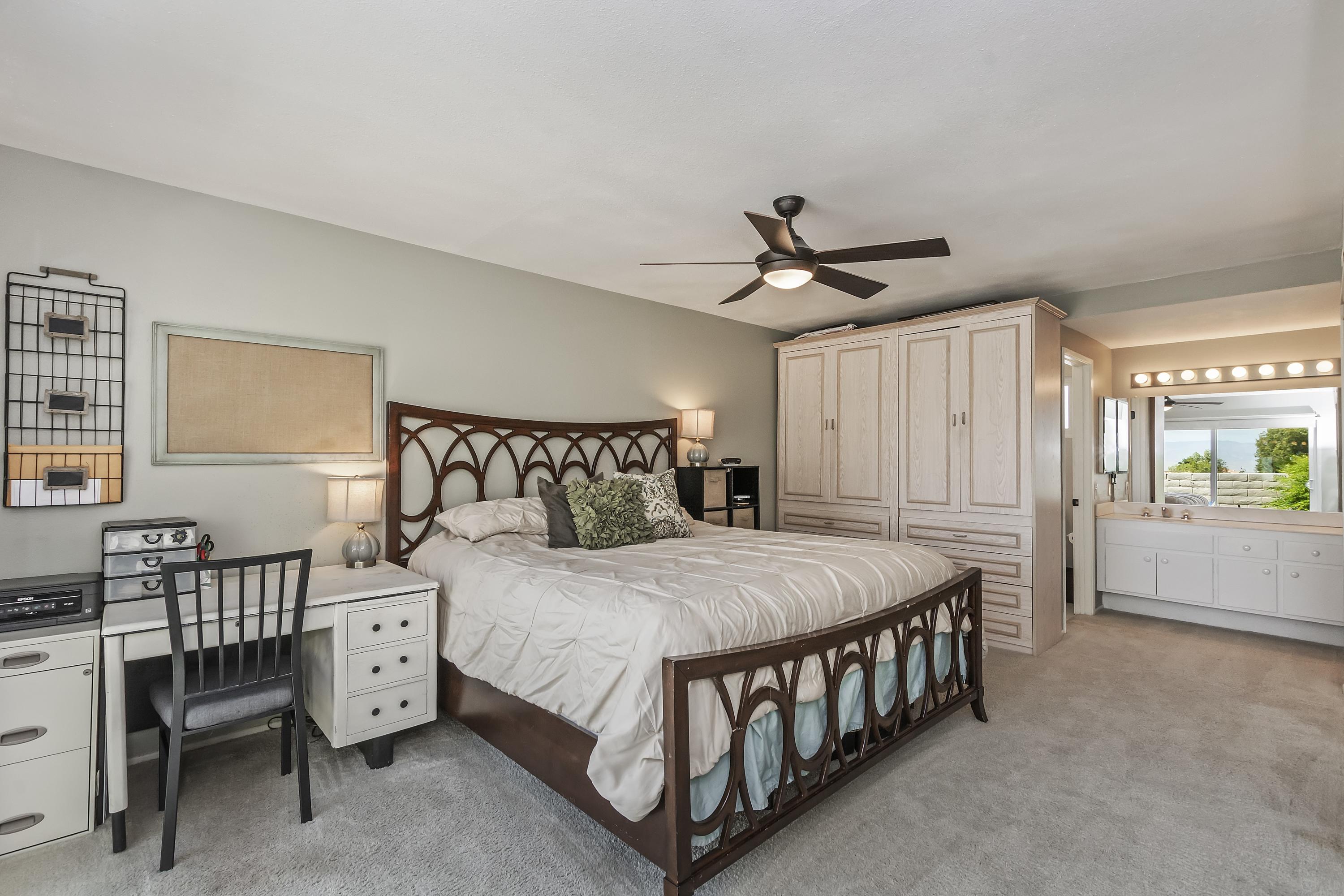 73149 Haystack Road Palm Desert, CA 92260 - Photo 21 of 32 a bedroom with a bed window and a table in it