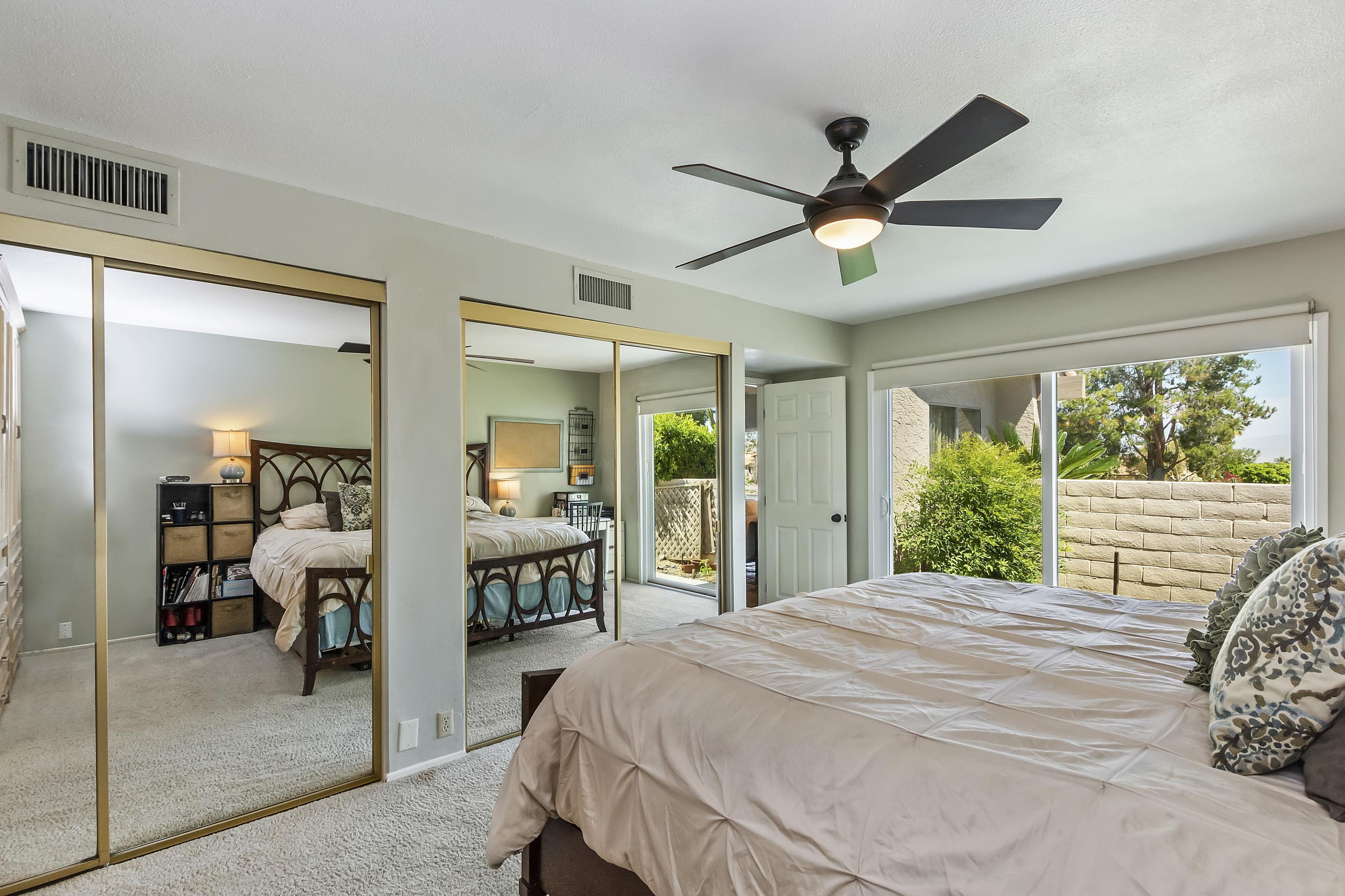 73149 Haystack Road Palm Desert, CA 92260 - Photo 23 of 32 a bedroom with a bed and a large window