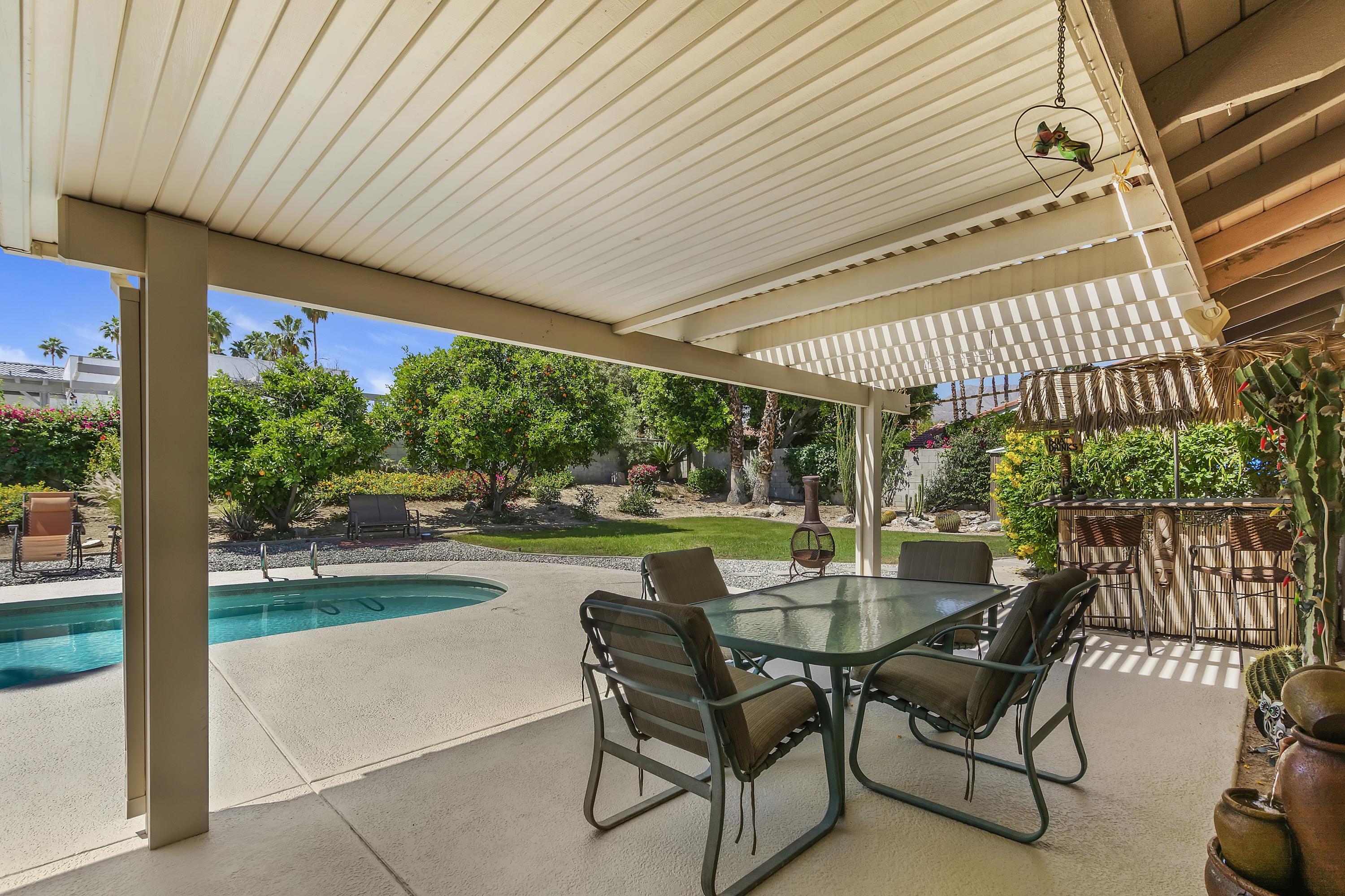 73149 Haystack Road Palm Desert, CA 92260 - Photo 25 of 32 a view of a patio with a table chairs and backyard