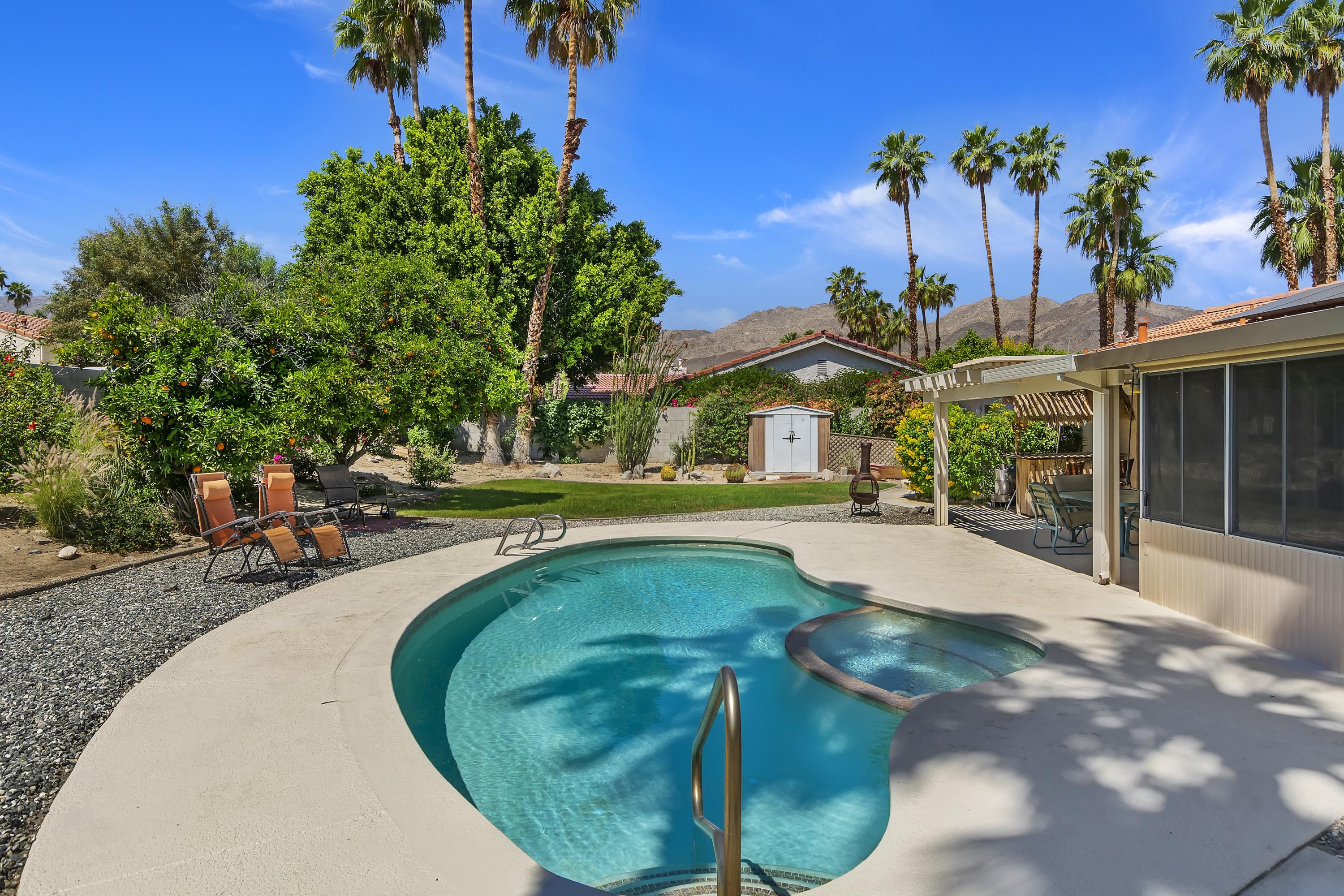 73149 Haystack Road Palm Desert, CA 92260 - Photo 28 of 32 a swimming pool with outdoor seating and yard