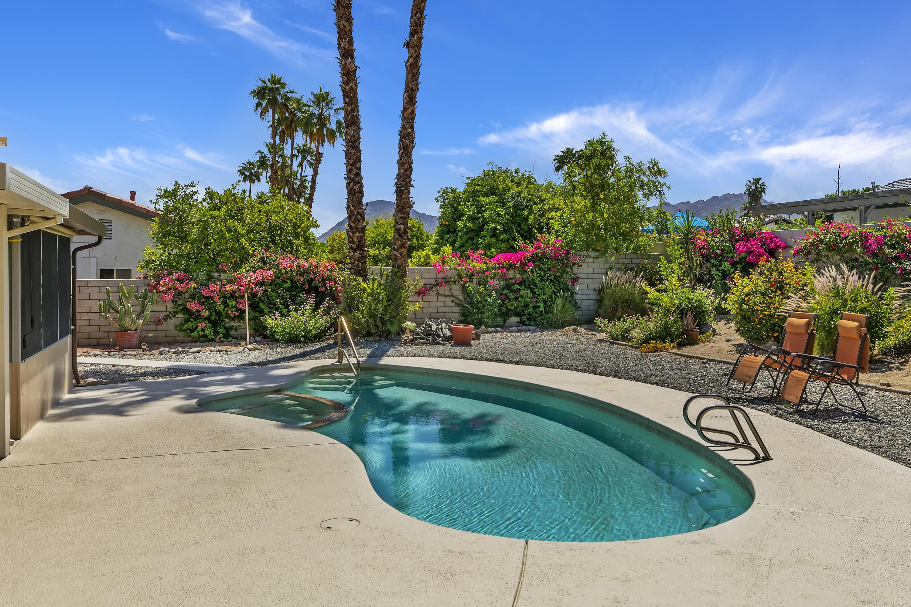 73149 Haystack Road Palm Desert, CA 92260 - Photo 29 of 32 a swimming pool with outdoor seating and plants