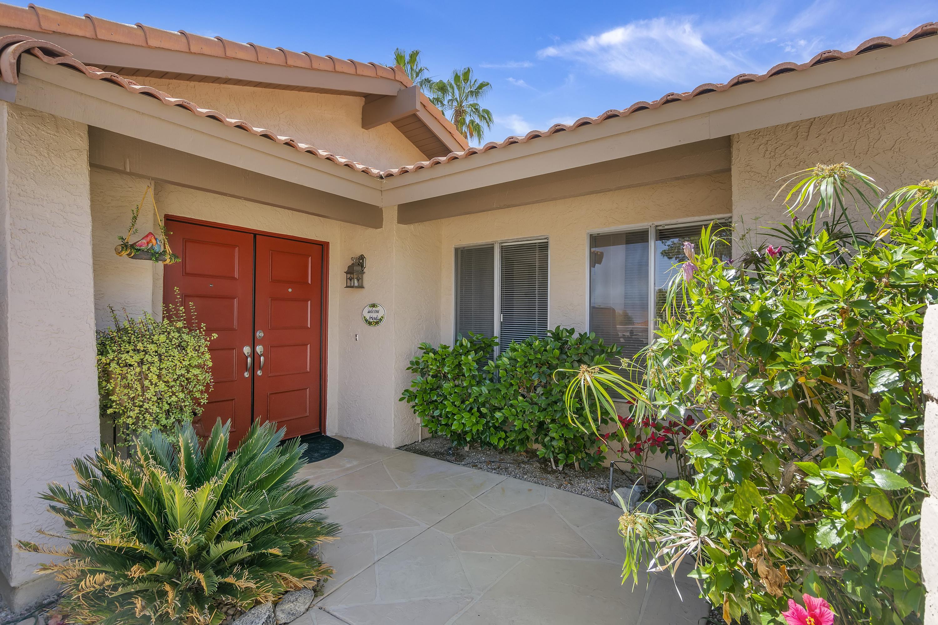 73149 Haystack Road Palm Desert, CA 92260 - Photo 4 of 32 front view of a house with potted plants