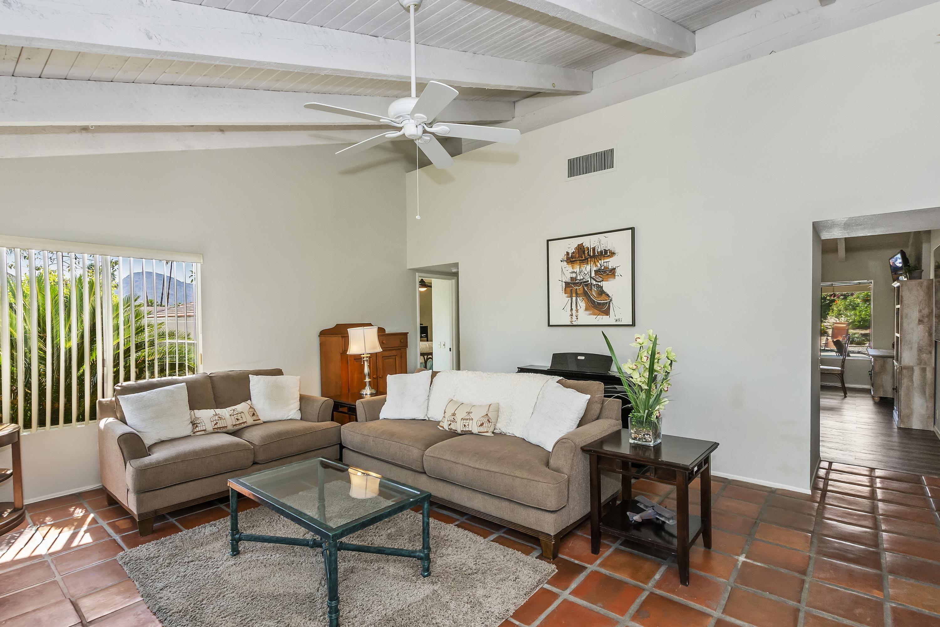 73149 Haystack Road Palm Desert, CA 92260 - Photo 7 of 32 a living room with furniture and a chandelier