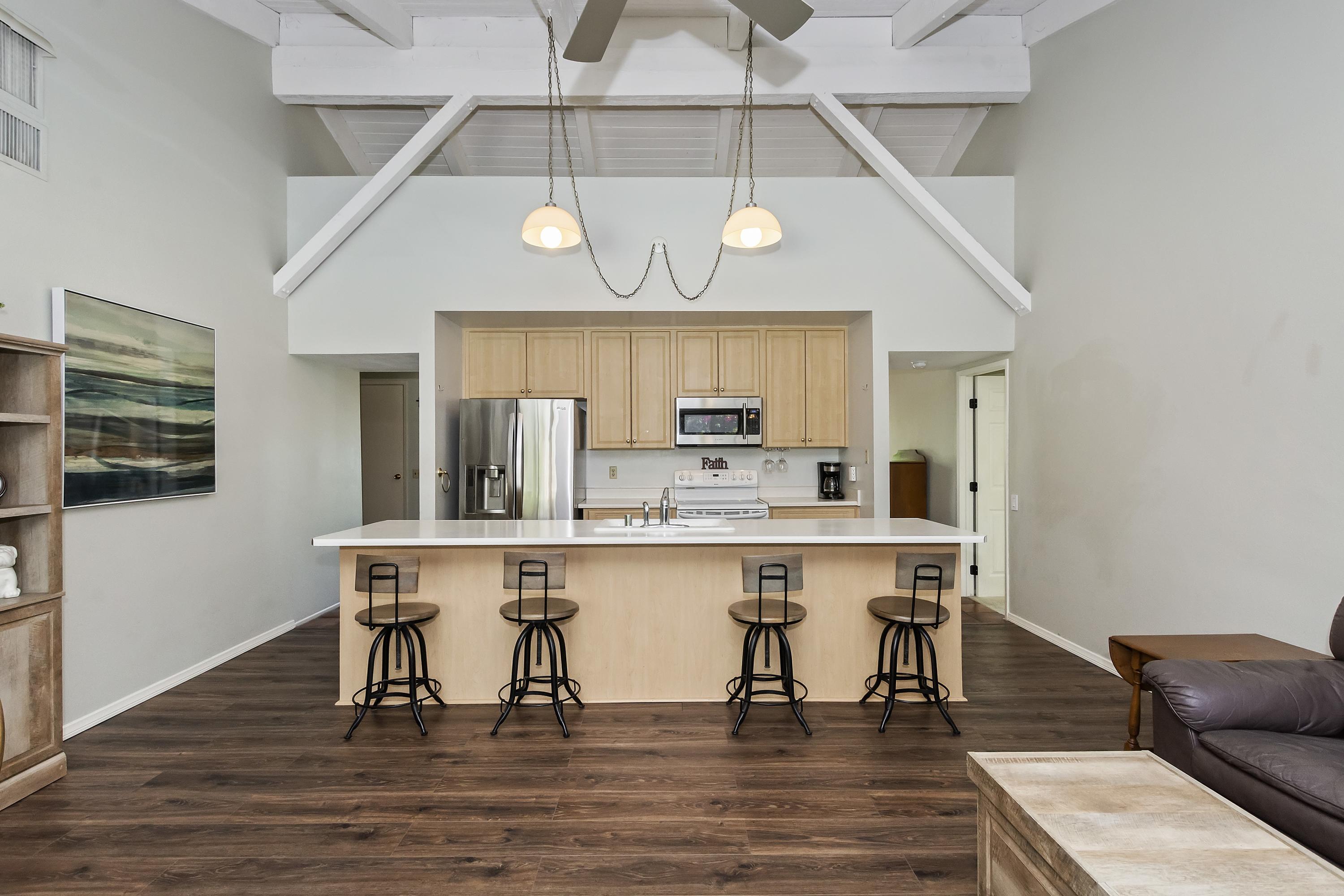 73149 Haystack Road Palm Desert, CA 92260 - Photo 8 of 32 a kitchen with stainless steel appliances a dining table chairs refrigerator and sink