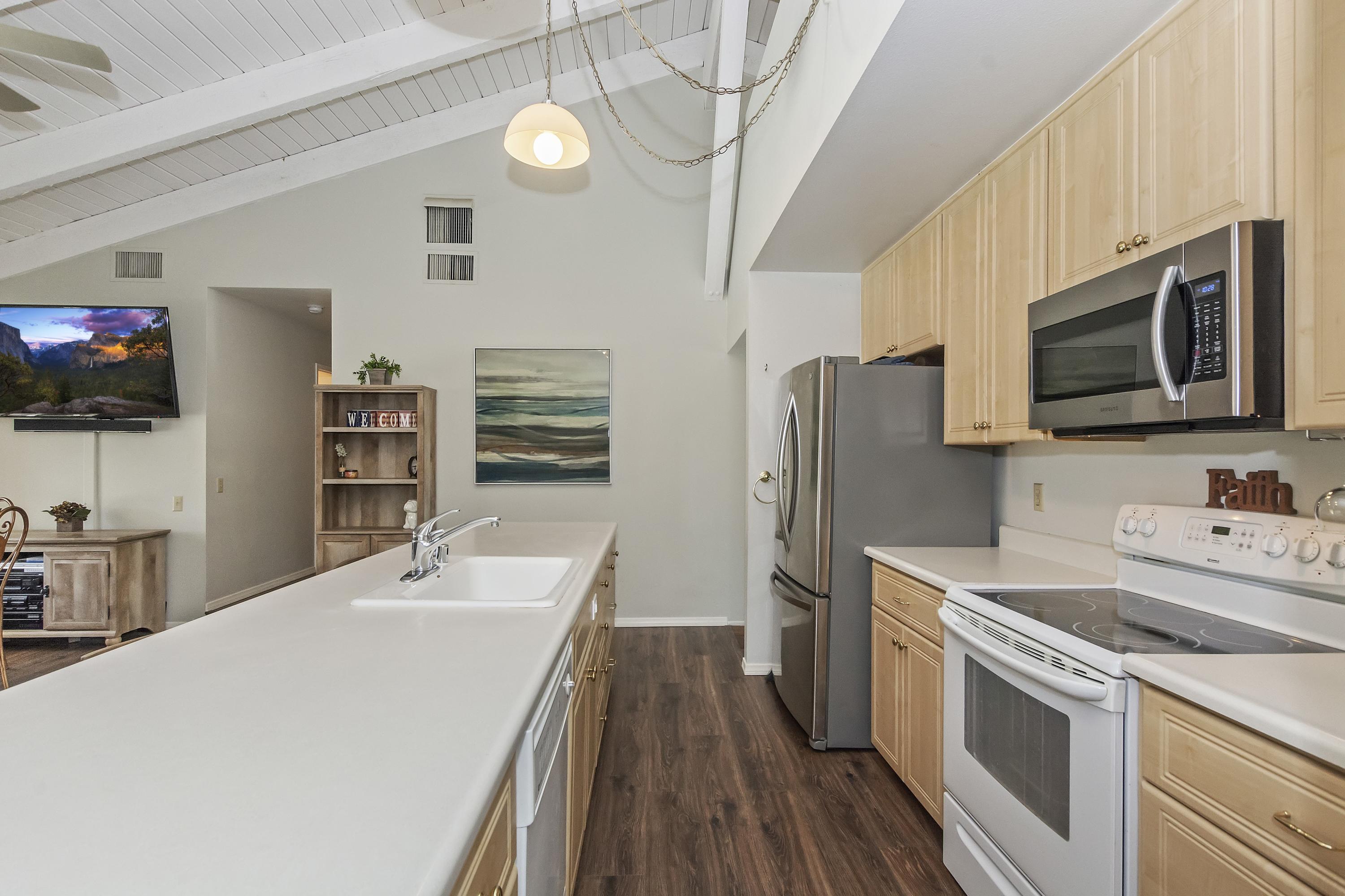 73149 Haystack Road Palm Desert, CA 92260 - Photo 10 of 32 a kitchen with stainless steel appliances a stove microwave and a refrigerator
