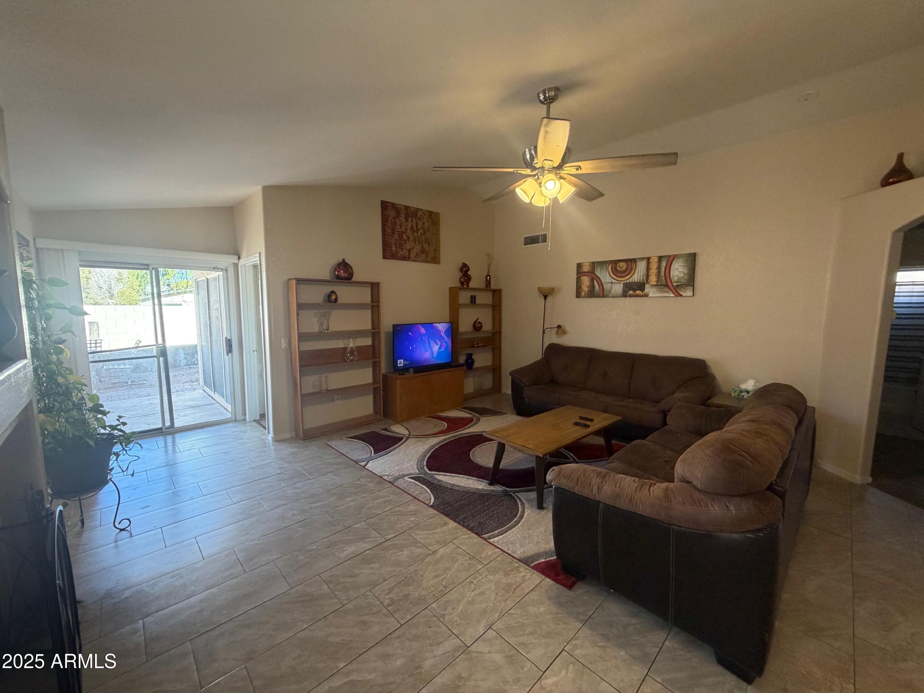 112 West Smoke Tree Road Gilbert, AZ 85233 - Photo 10 of 37 a living room with furniture and a flat screen tv