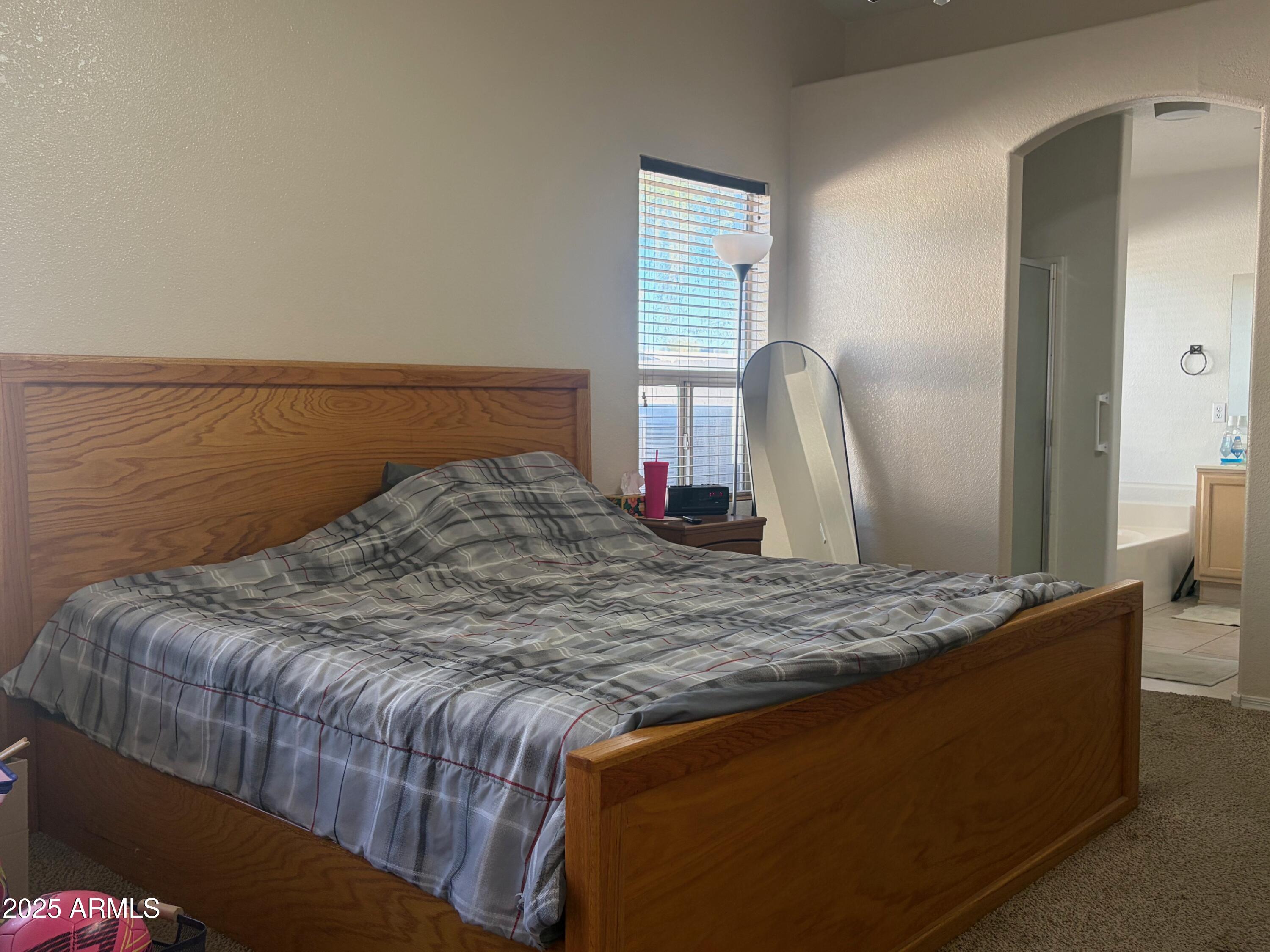 112 West Smoke Tree Road Gilbert, AZ 85233 - Photo 21 of 37 a bedroom with a bed and dresser
