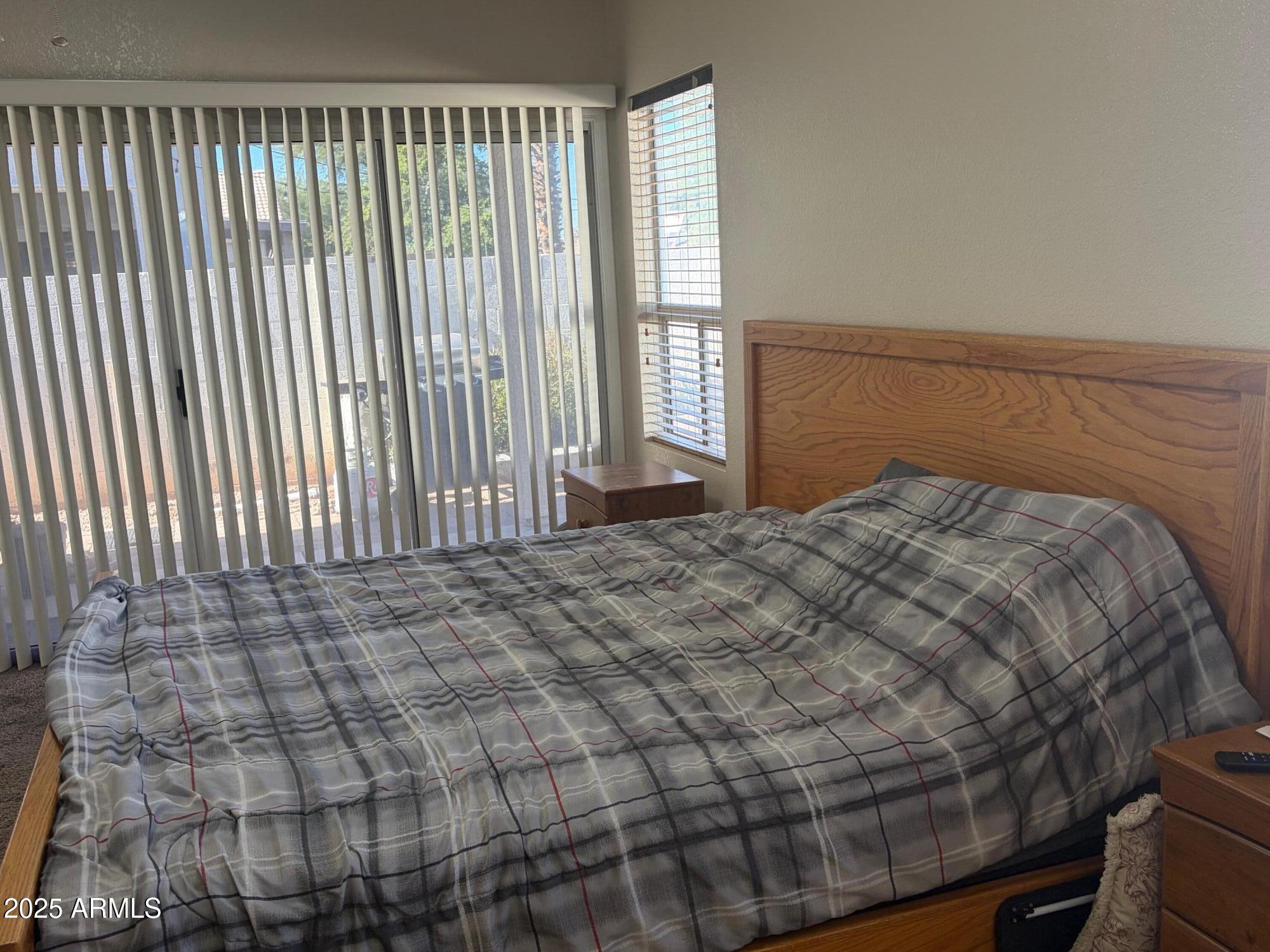 112 West Smoke Tree Road Gilbert, AZ 85233 - Photo 23 of 37 a bed sitting in a bedroom next to a window