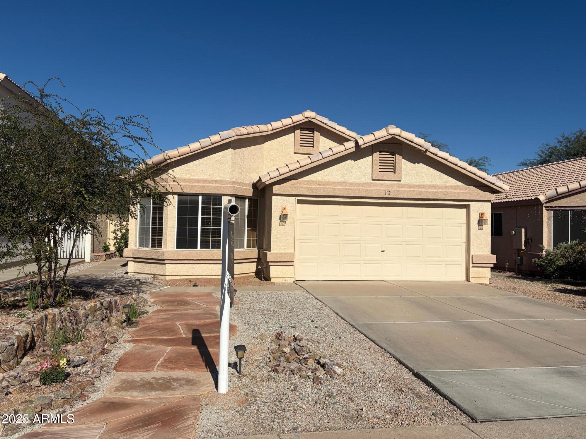 112 West Smoke Tree Road Gilbert, AZ 85233 - Photo 3 of 37 a front view of a house with a yard and garage