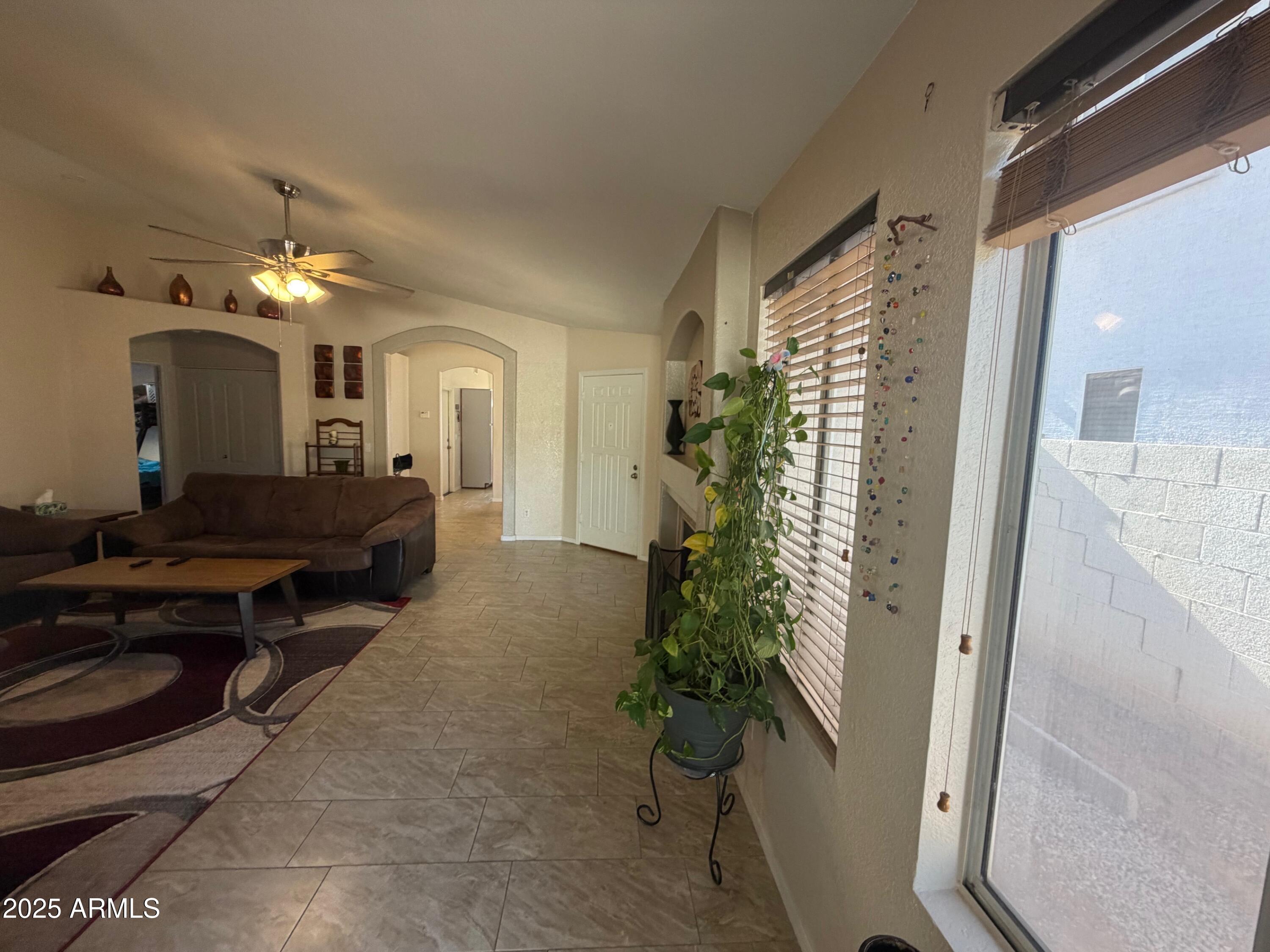 112 West Smoke Tree Road Gilbert, AZ 85233 - Photo 7 of 37 a living room with furniture and a potted plant