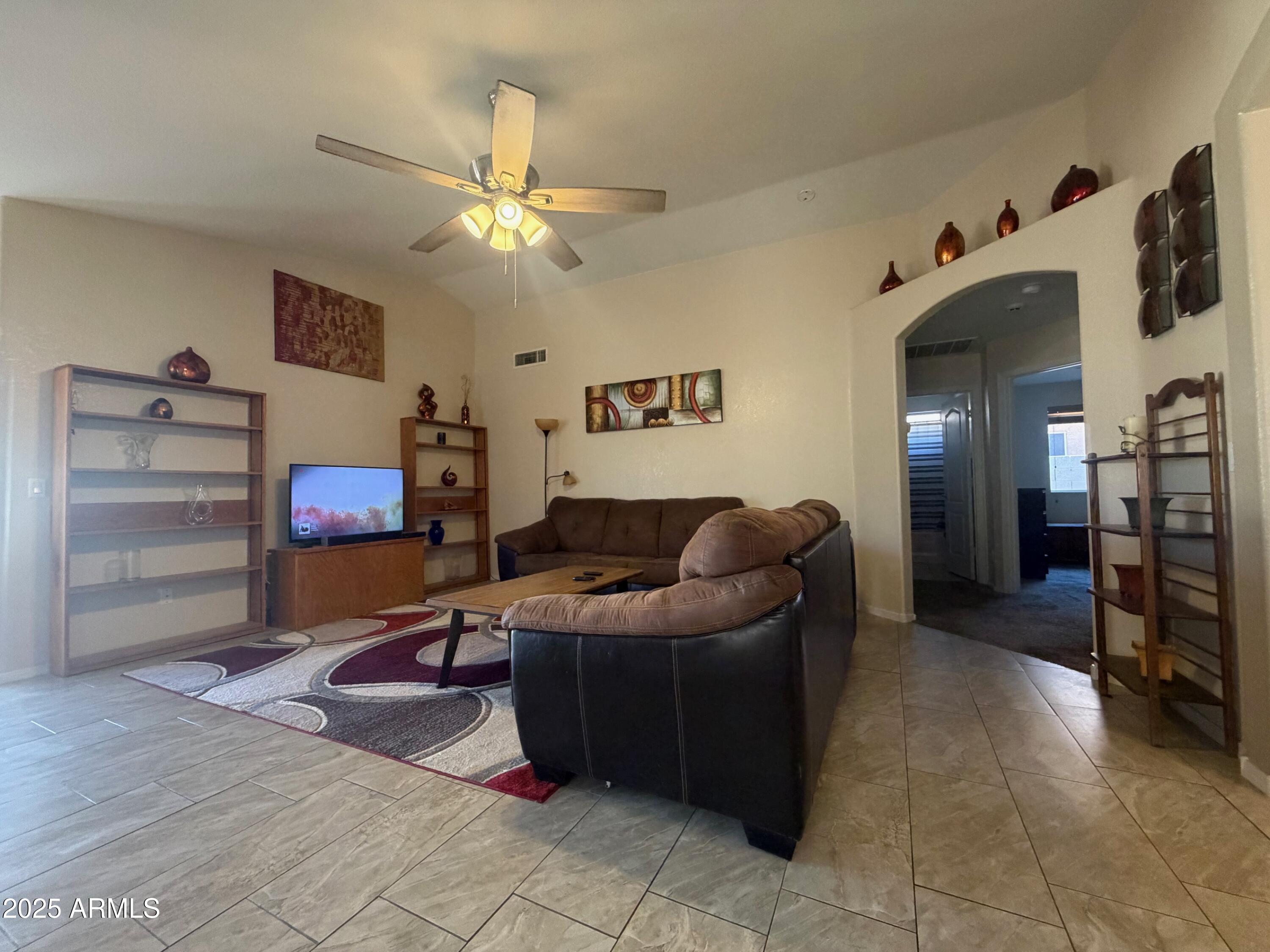 112 West Smoke Tree Road Gilbert, AZ 85233 - Photo 9 of 37 a living room with furniture and a flat screen tv