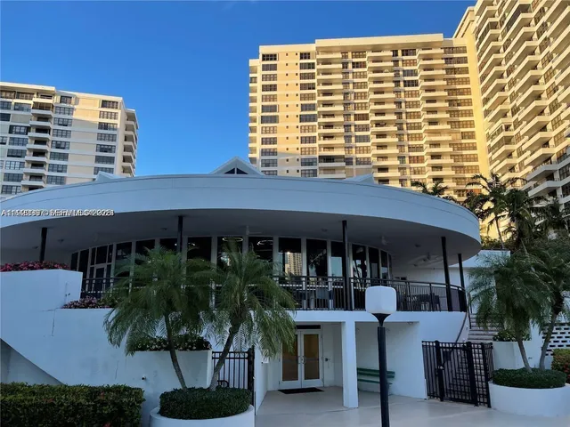 a front view of a house with swimming pool and patio