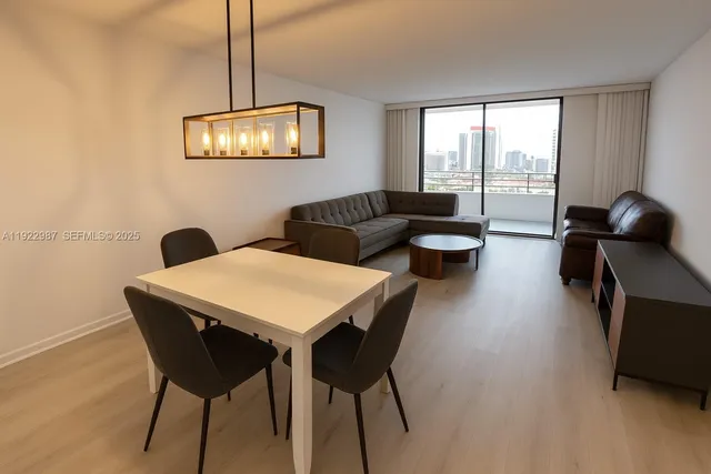 a view of a dining room with furniture wooden floor and a chandelier