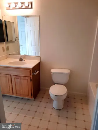 a bathroom with a sink toilet and mirror