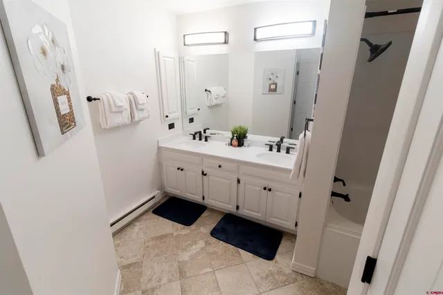 a bathroom with a sink toilet and mirror