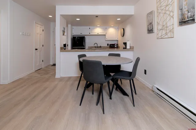 a view of a dining room with furniture and wooden floor