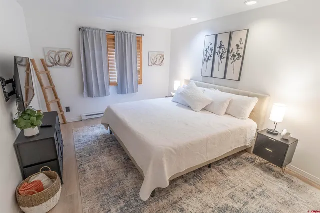 a bedroom with a bed and a couch